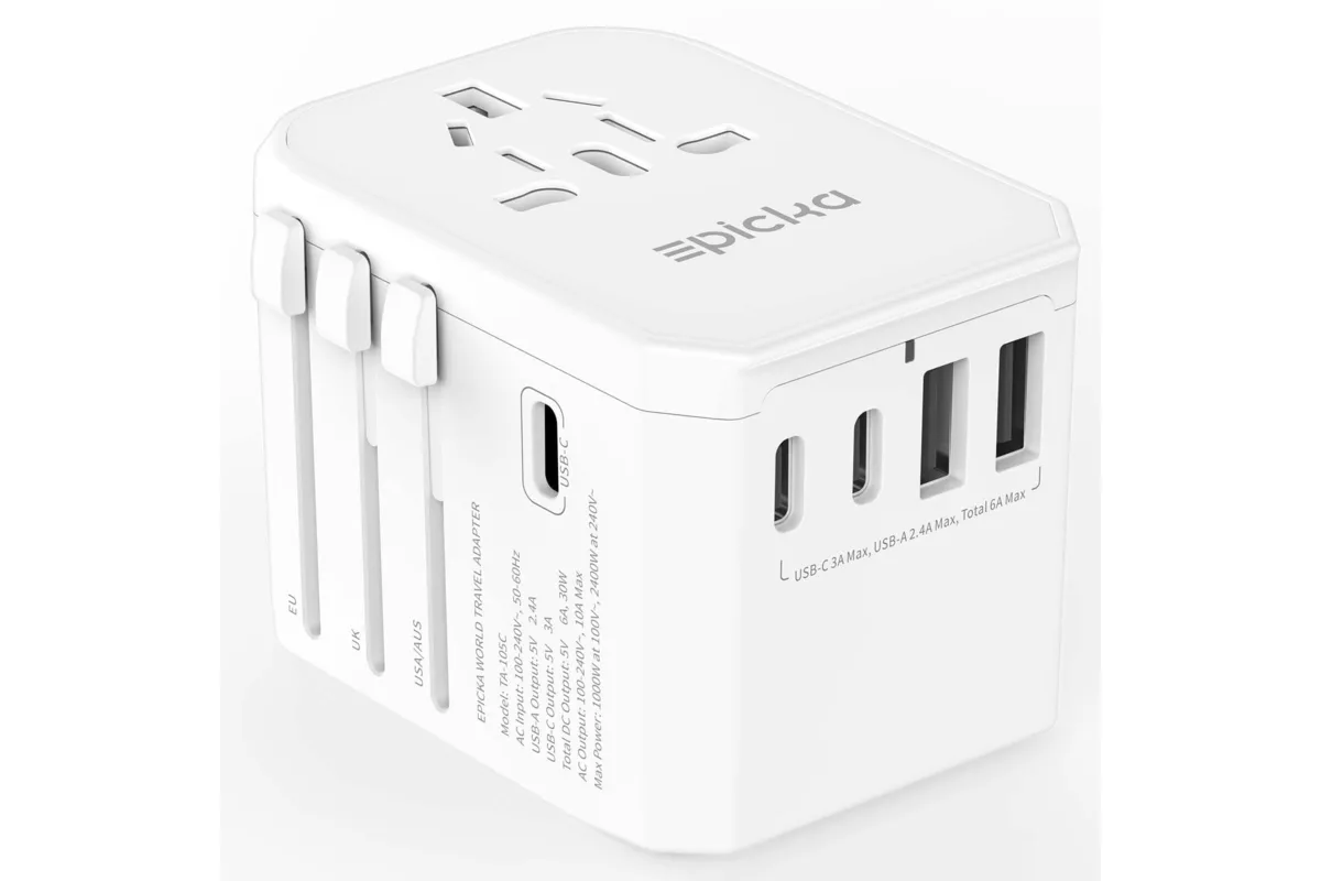 best travel adapter comparison flat lay on wooden desk